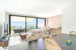 a living room with a couch and a table at Villa Ezzio Los Alcazares in Los Alcázares