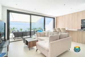 a living room with two white couches and a table at Villa Ezzio Los Alcazares in Los Alcázares