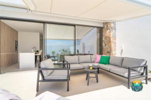a living room with a couch and chairs at Villa Ezzio Los Alcazares in Los Alcázares