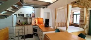a small kitchen with a small apartment with a bed at Loft House Syros in Ermoupoli +15 photos
