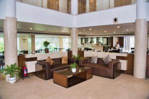 a large living room with couches and a bar at Peerless Hotel Hyderabad in Hyderabad