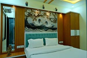 a bedroom with a large painting above a bed at Gehlot Paradise Hotel in Nāgaur +24 photos