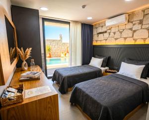 a hotel room with two beds and a window at Kiva Alaçatı Hotel By Amarillo in Çeşme +24 photos