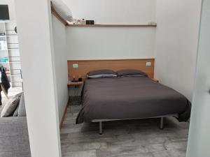 a bedroom with a bed with a wooden headboard at La Cittadella ex WAVA Spa in Brugnato +7 photos