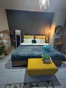 a bedroom with a large bed and a yellow table at Amaryllis apartment 23 in Serres