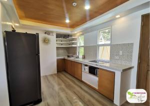 a kitchen with a black refrigerator in a room at Newly Built Private Villa with Pool in Cainta in Cainta