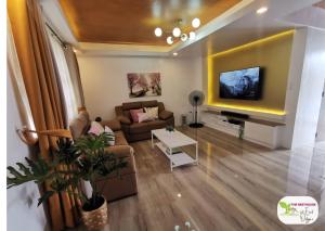 a living room with a couch and a tv at Newly Built Private Villa with Pool in Cainta in Cainta