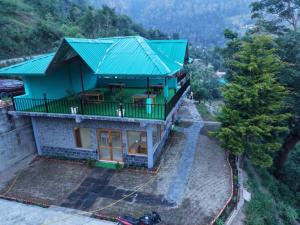 an overhead view of a house with a green roof at Jungle Valley Camp & Resort in Nainital