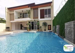 a villa with a swimming pool in front of a house at Newly Built Private Villa with Pool in Cainta in Cainta