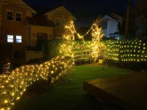 a garden with christmas lights in a yard at KandoStay 伊豆高原パークガーデン in Ito