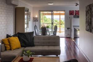 a living room with a couch and a table at Something a little different in Albany