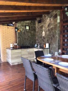 a dining room with a table and chairs and a kitchen at Lake House in Svityazʼ