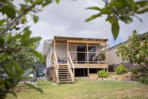 a house with a deck and a staircase at Something a little different in Albany