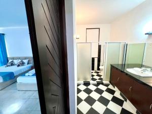 a bathroom with a bed and a sink and a mirror at Hotel One Sixty in Dehiwala