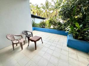 a patio with two chairs and a bench and plants at Hotel One Sixty in Dehiwala