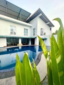 a house with a swimming pool in front of it at Hotel One Sixty in Dehiwala