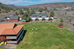 an aerial view of a house with a yard at Crooked River Ranch Cabins in Terrebonne