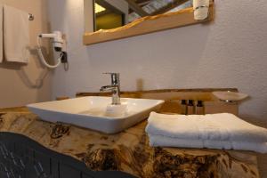 a bathroom with a sink on a marble counter with a mirror at Gizli Cennet Villages Hotel in Fethiye