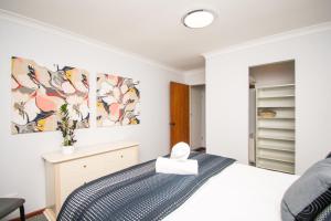 a bedroom with a bed and a dresser and a mirror at Something a little different in Albany