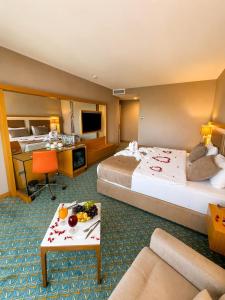 a hotel room with two beds and a television at Blue Sea Hotel in Trabzon