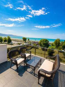 a patio with three chairs and a table on a balcony at Blue Sea Hotel in Trabzon +49 photos