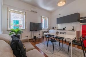 a living room with a couch and a table at Effealatapartments - Appartamento del Duca in Senigallia