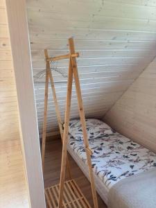 a room with a bunk bed in a attic at PAKLADA Domek całoroczny 2 in Bak