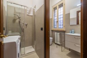 a bathroom with a shower and a toilet and a sink at Effealatapartments - Appartamento del Duca in Senigallia +42 photos