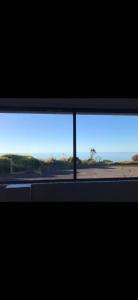 a view of a window with a view of the desert at The Bass Horizon - 5 bedrooms - 10 people - Bass Strait View in Devonport
