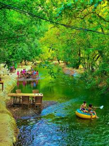 a group of people riding on a raft in a river at Gizli Cennet Villages Hotel in Fethiye +9 photos