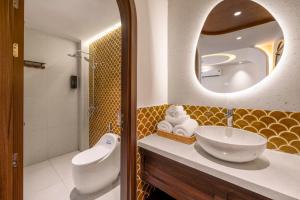 a bathroom with a sink and a mirror at Vista Del Sol Hotel in Danang +70 photos