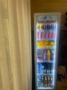 a refrigerator filled with lots of sodas and drinks at Guest house River side in Adishi