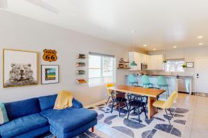 a living room with a blue couch and a table at The Pine House in Flagstaff