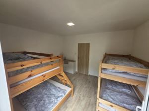 a bedroom with two bunk beds in a room at Relaxační centrum Orion in Roudná +11 photos