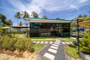 a building with a blue roof and glass at The Samui Villa Retreat in Ban Bang Po