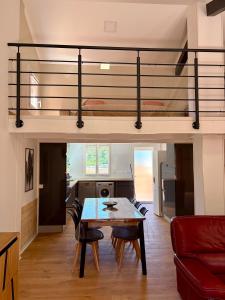 a living room with a table and a loft bed at Résidence les Caraibes in Sérignan