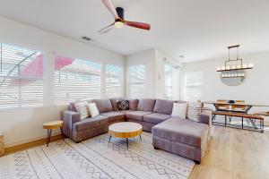 a living room with a couch and a ceiling fan at Tranquil Desert Sanctuary in Indio