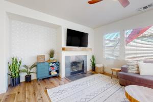 a living room with a couch and a fireplace at Tranquil Desert Sanctuary in Indio