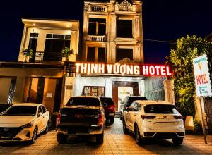 a group of cars parked in front of a think wrong hotel at Thịnh Vượng Hotel in Dong Hoi