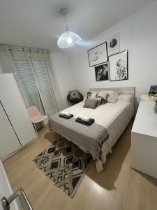 a bedroom with a bed and a rug at Suite Estébanes in Zaragoza