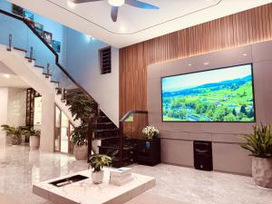 a lobby with a large screen tv in a building at Thịnh Vượng Villa in Dong Hoi