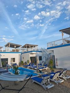 a resort with a swimming pool and lounge chairs at Beach Bungalows Costinesti in Costinesti