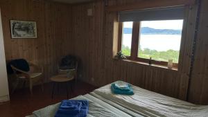 a bedroom with a bed and a window at Comfortable B&B near Senja in Brostadbotn