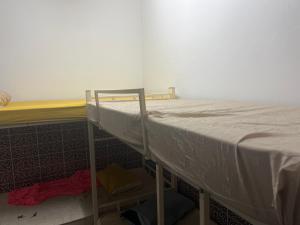 a bunk bed in a room next to a wall at Beach hostel in Muscat