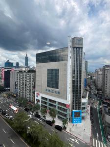a large building with a clock on it in a city at 鼎正國際商務旅館 in Taipei