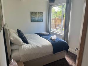 a bed with two pillows and a window in a room at Beamish Lodge in Stanley