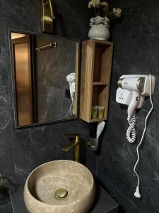 a bathroom with a sink and a mirror at Golden Star Cottage in Kazbegi