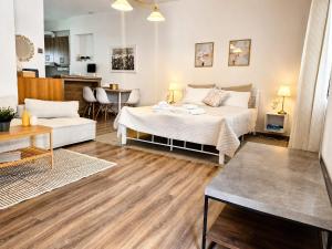 a bedroom with a bed and a living room at Cloud9 Airport Suites in Koropi