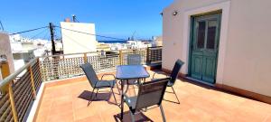 a balcony with a table and chairs on a balcony at Loft House Syros in Ermoupoli