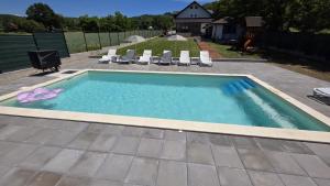 a swimming pool in a yard with chairs and a house at Casa Anto in Călimăneşti